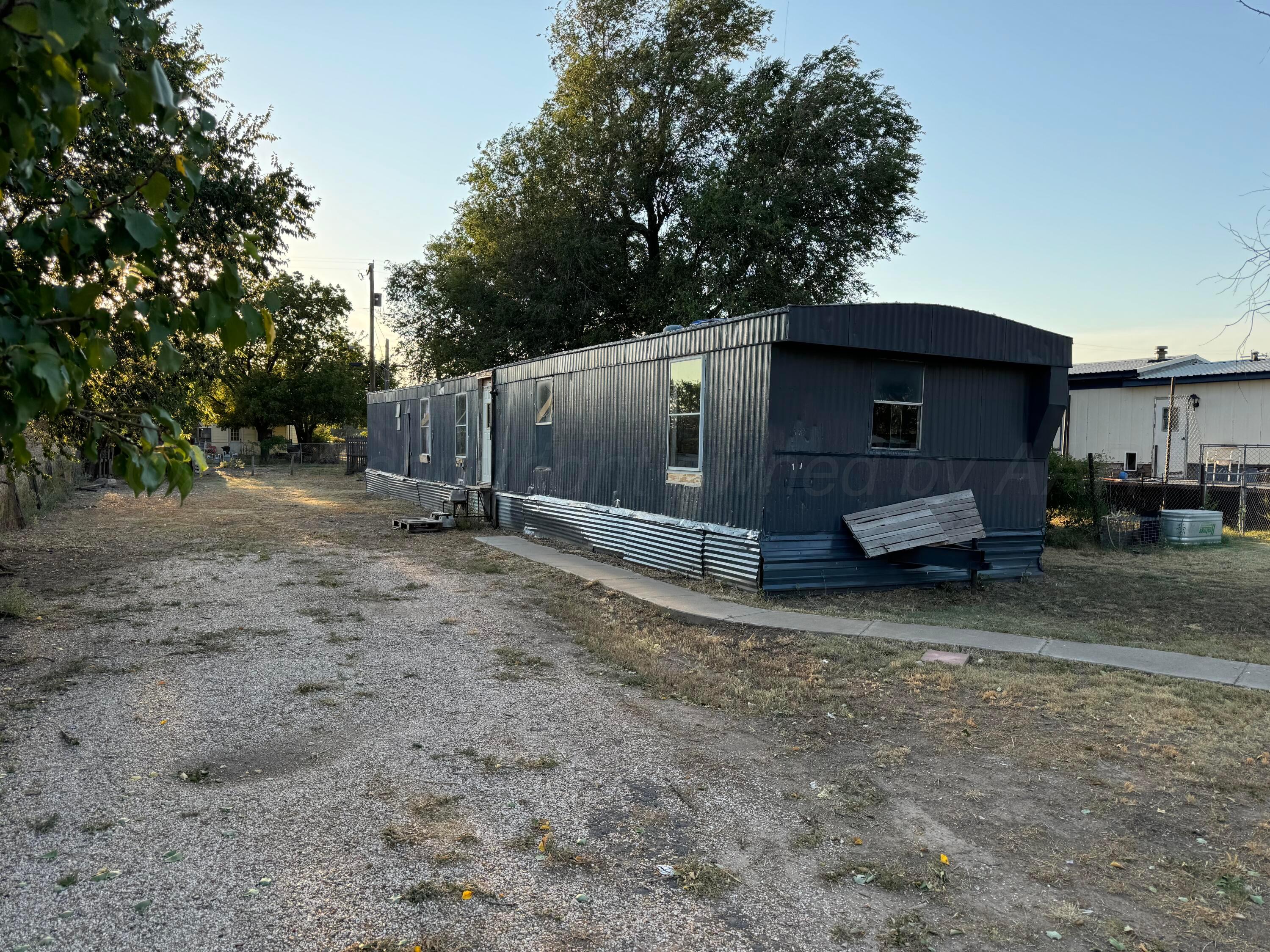 a view of a barn in the middle of a yard