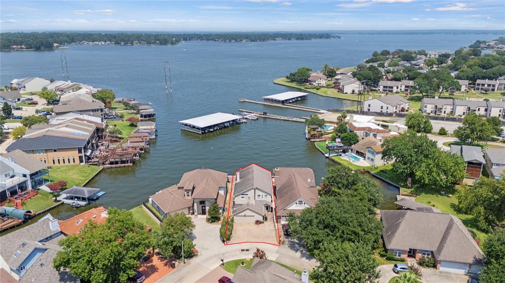 an aerial view of a house with outdoor space and lake view