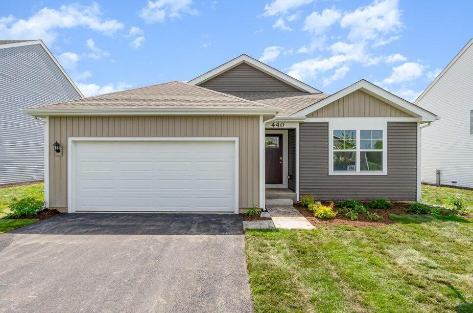 a front view of a house with a yard and garage