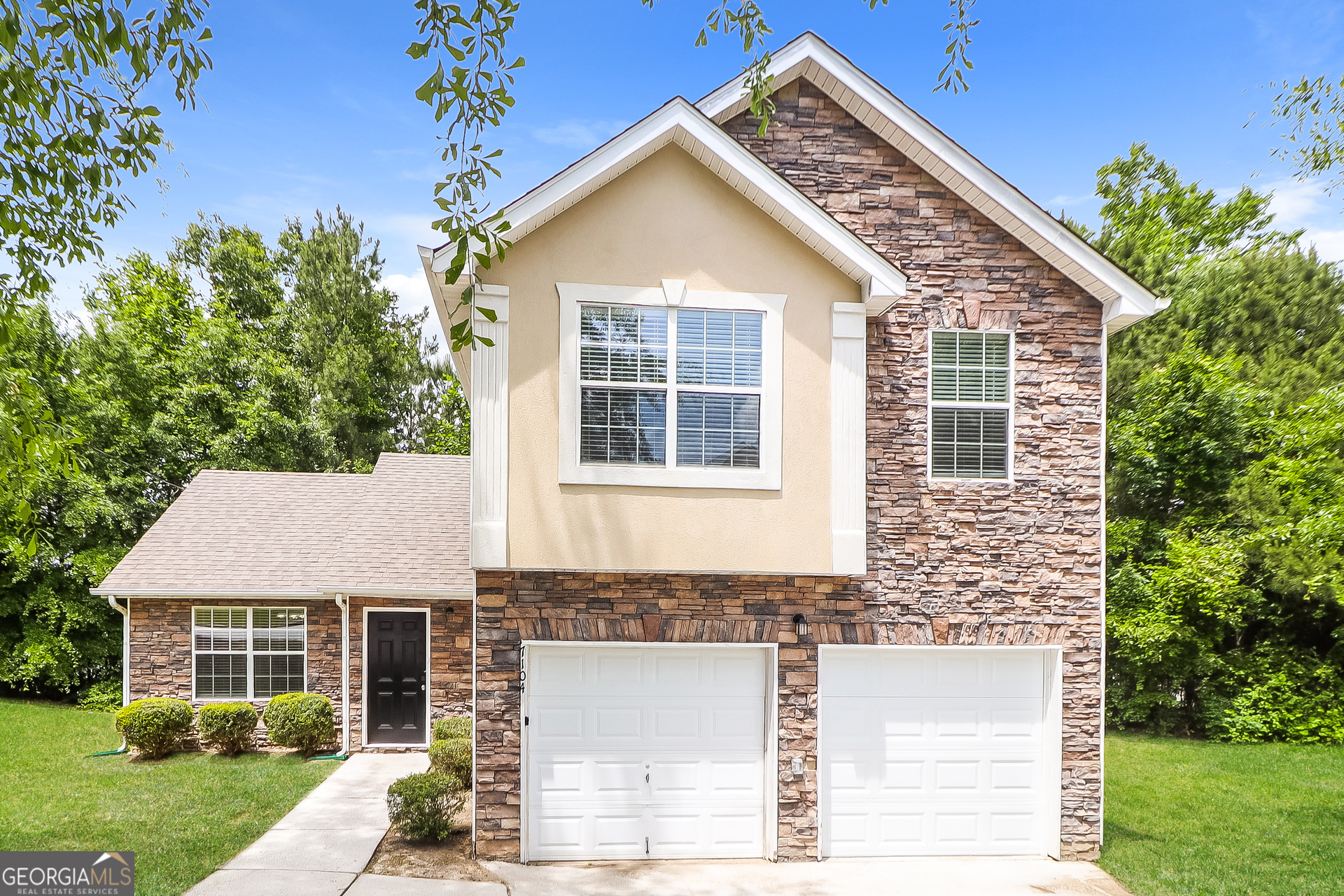 a front view of a house with a yard