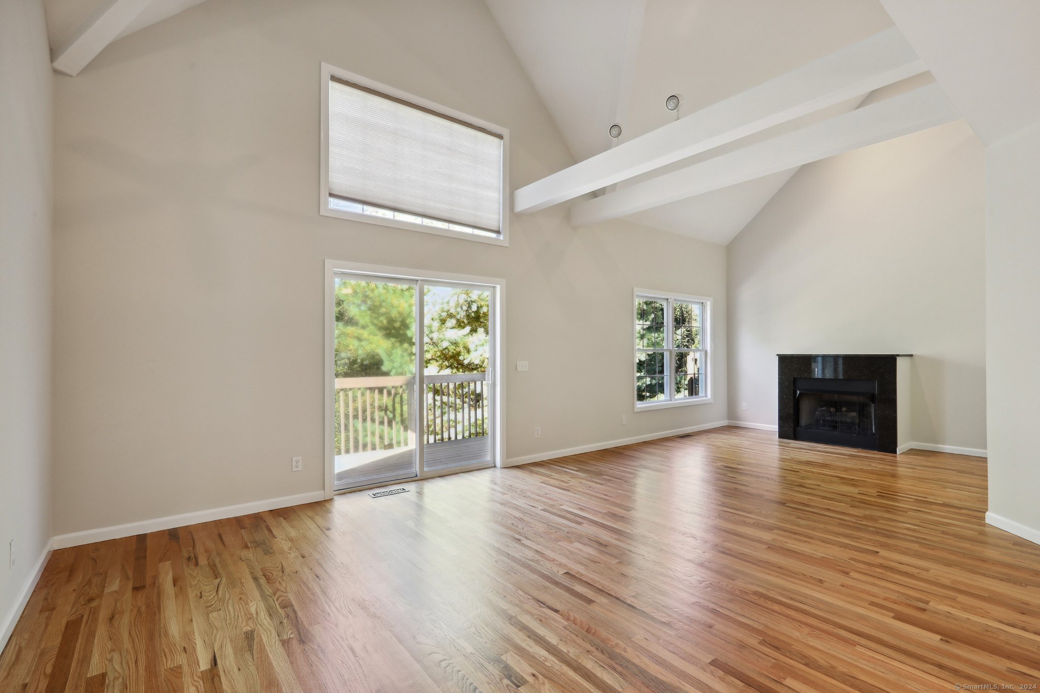 Living room and dining area with vaulted ceilings