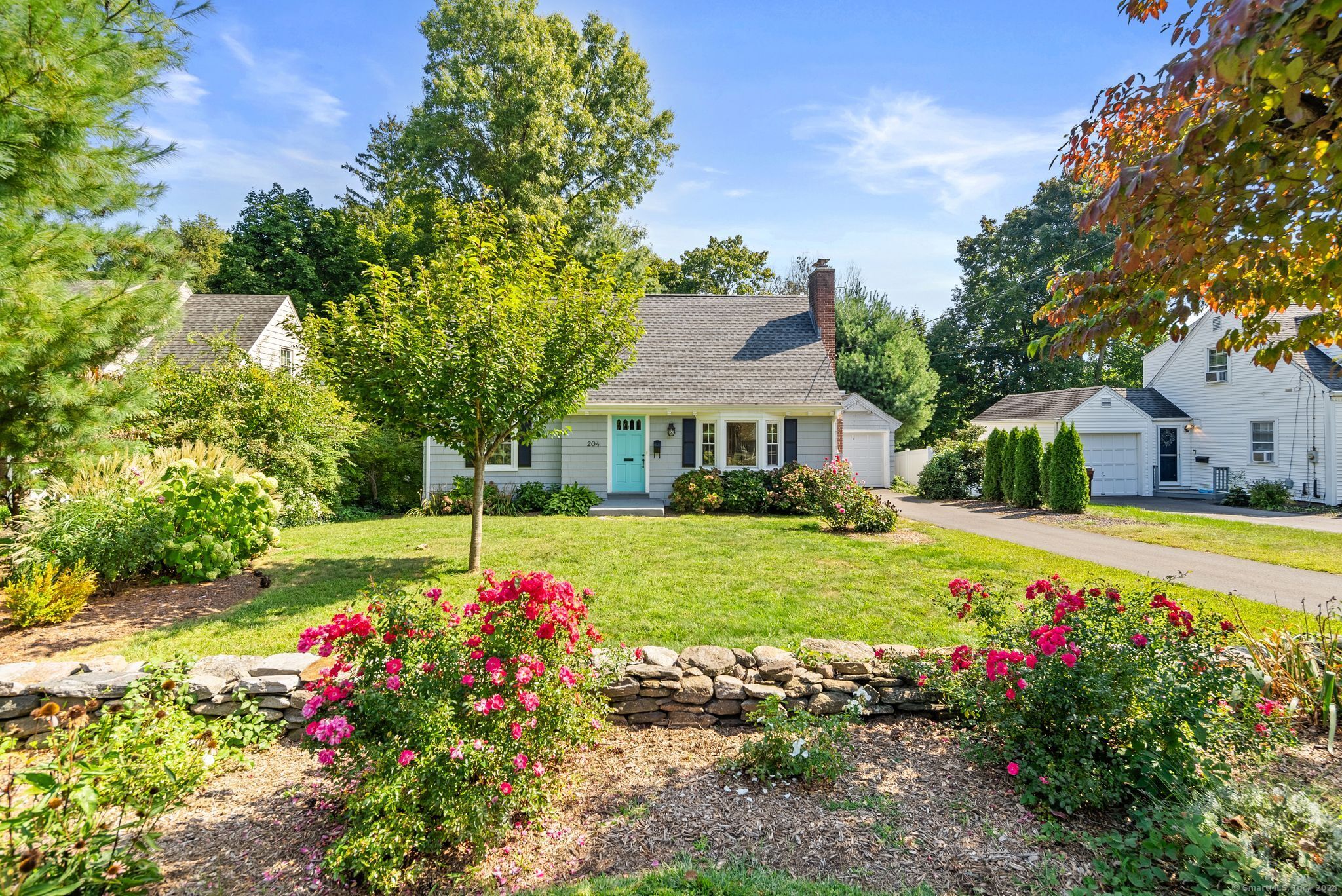 a view of a house with a yard and garden