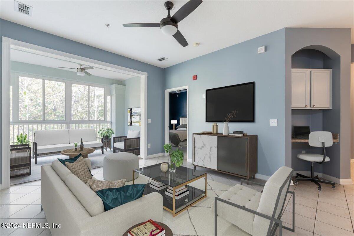 a living room with furniture and a flat screen tv