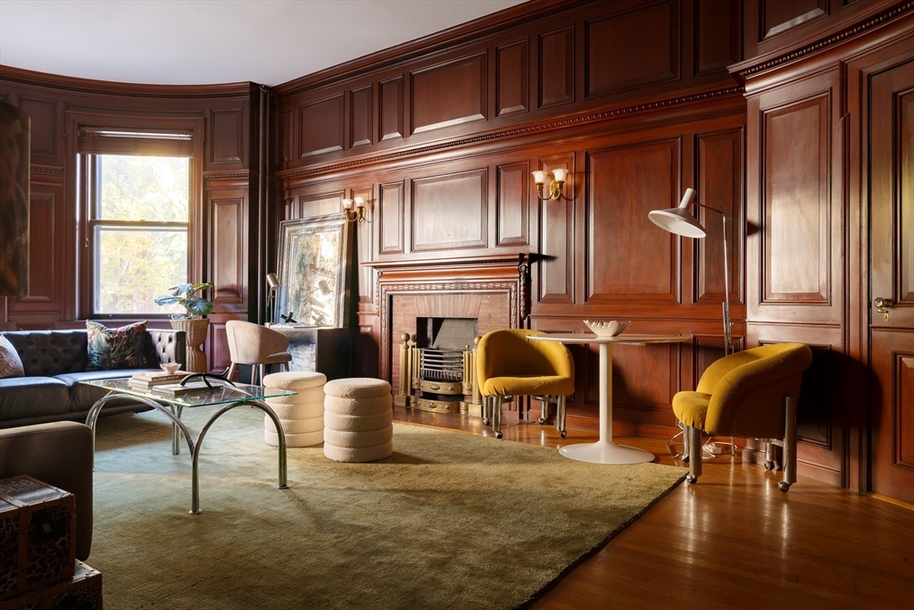 a living room with furniture a window and a fireplace