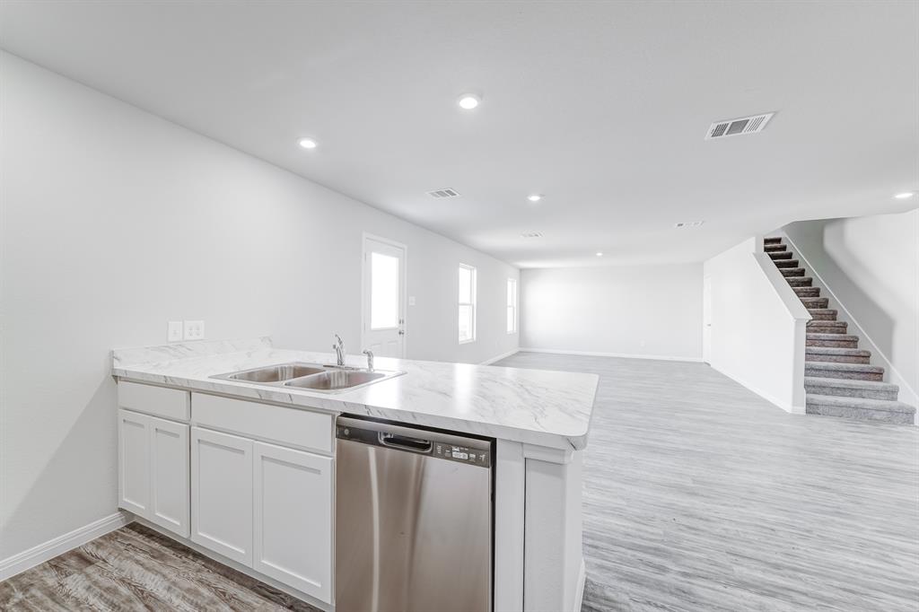 a kitchen with sink and mirror