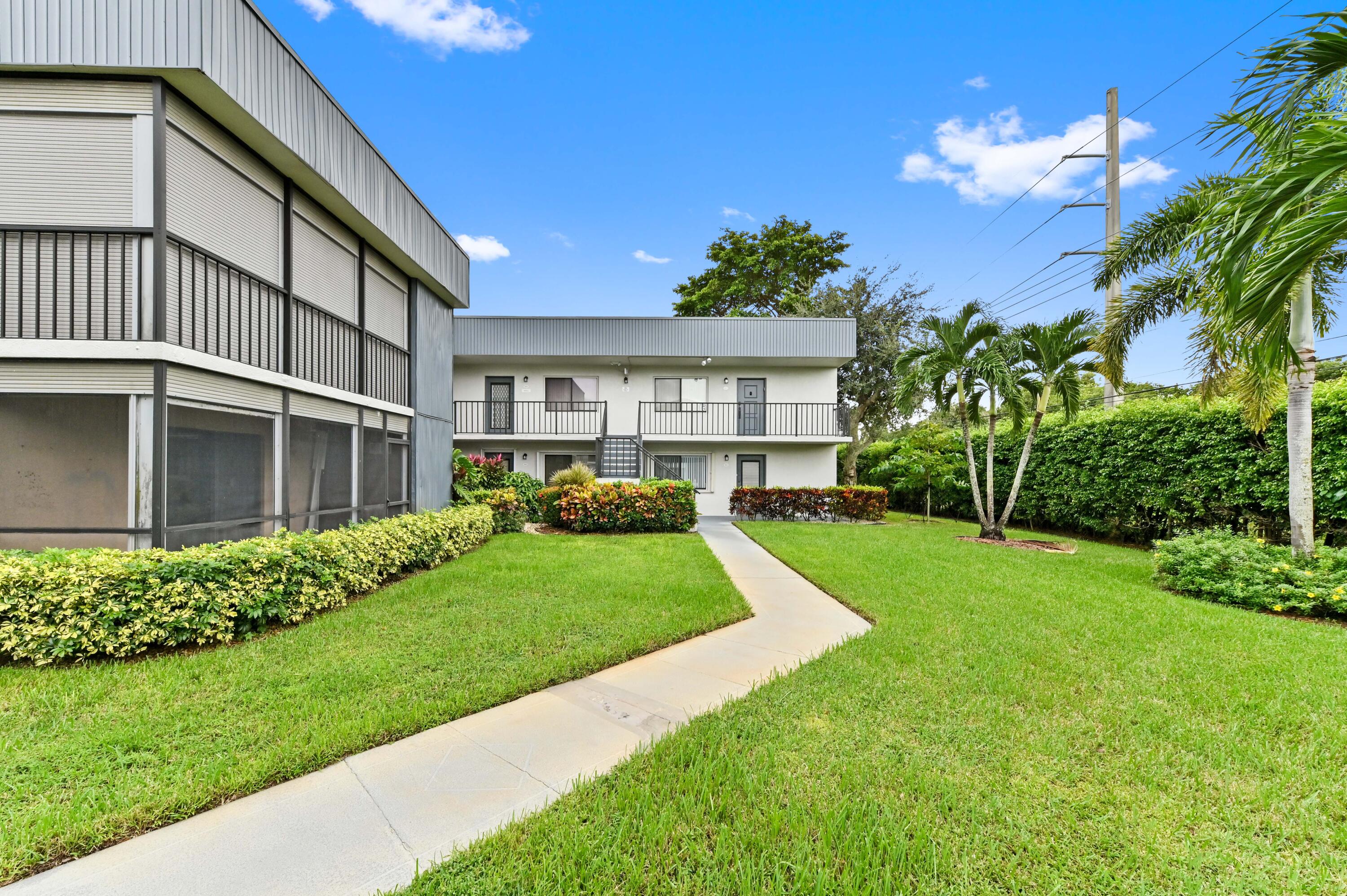 a view of a house with a yard and plants