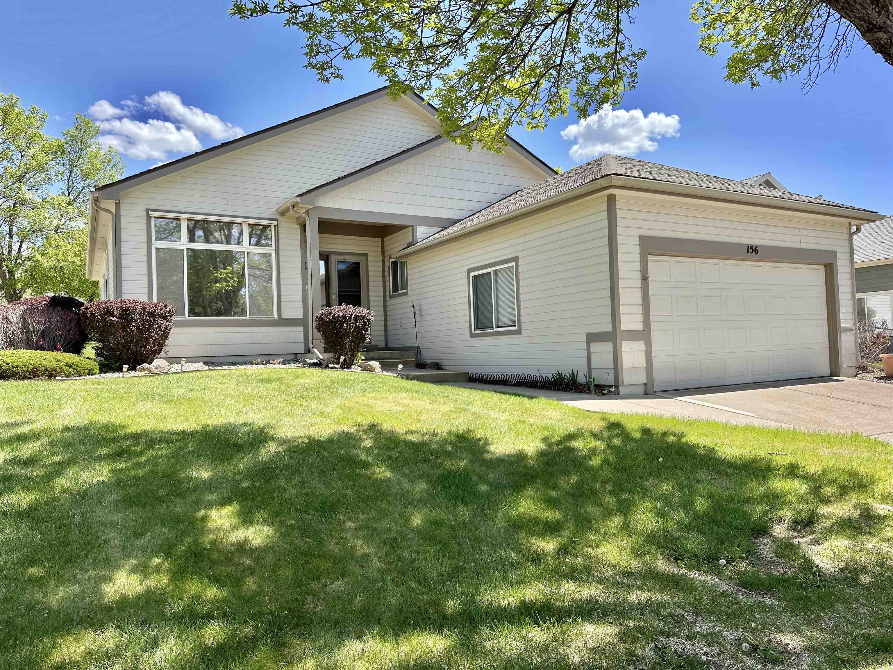 a front view of a house with yard and outdoor seating