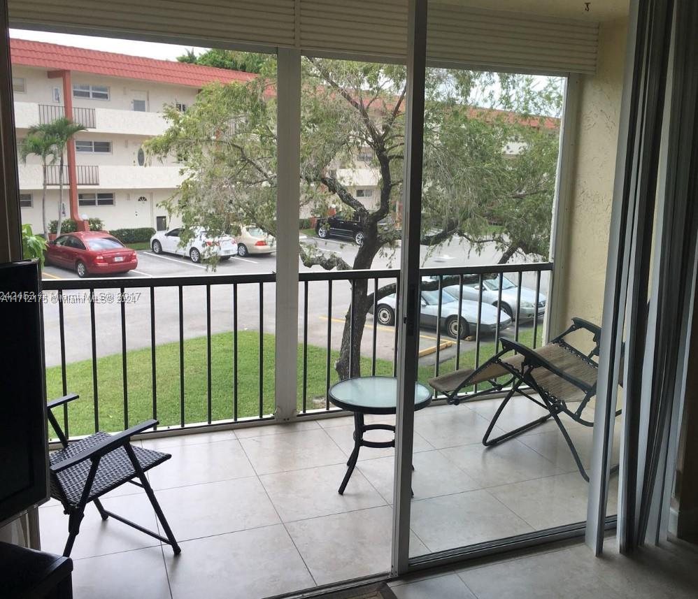 a view of a chairs and table in the balcony