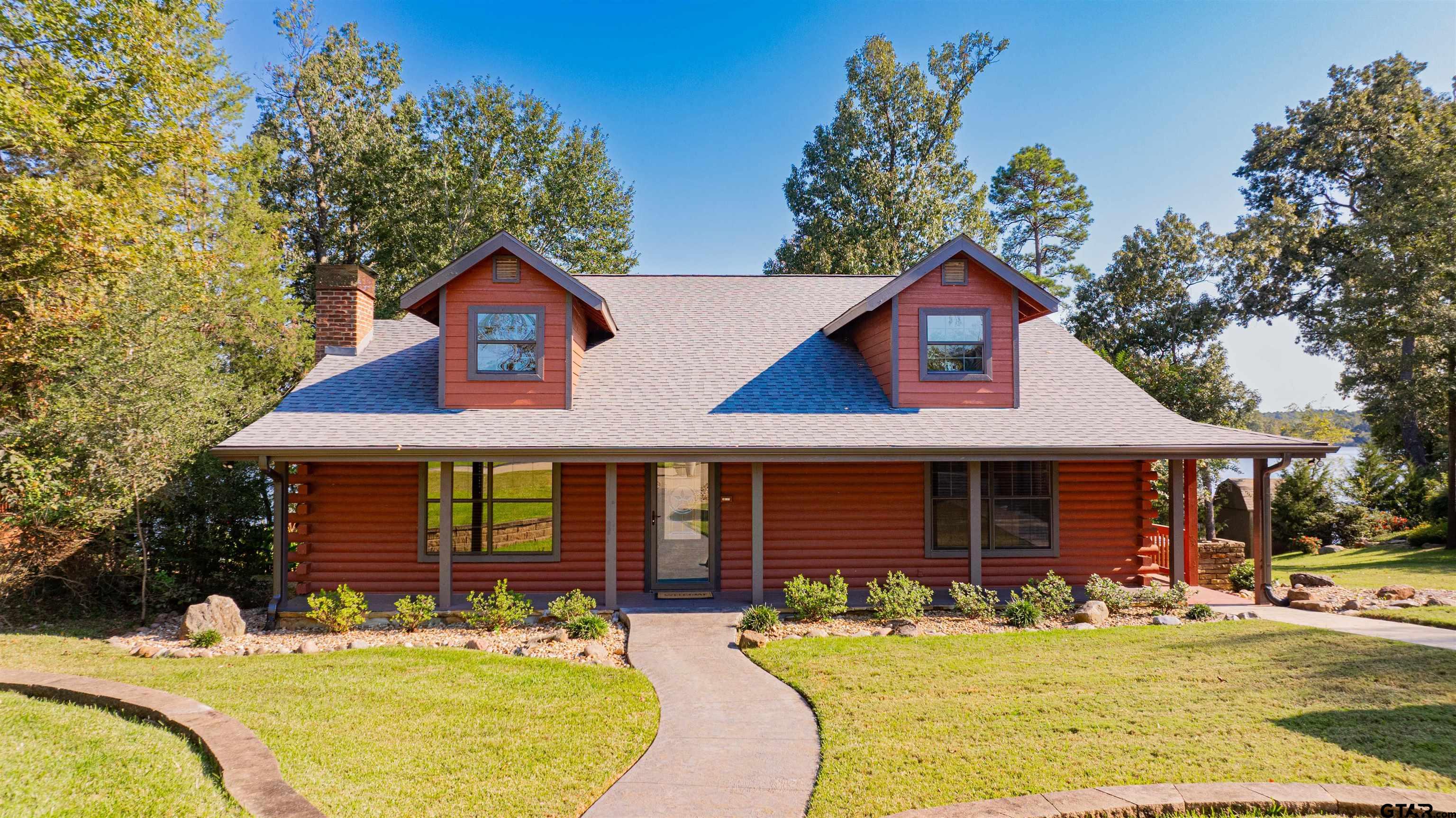 a front view of a house with a yard patio and fire pit