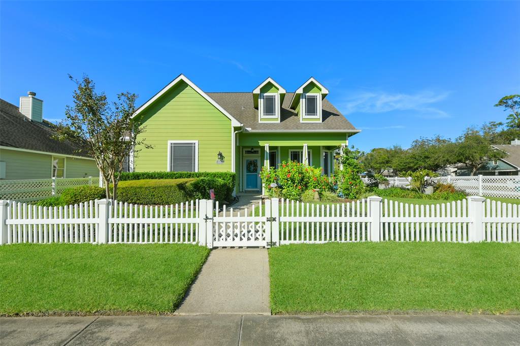 a front view of a house with a garden and plants