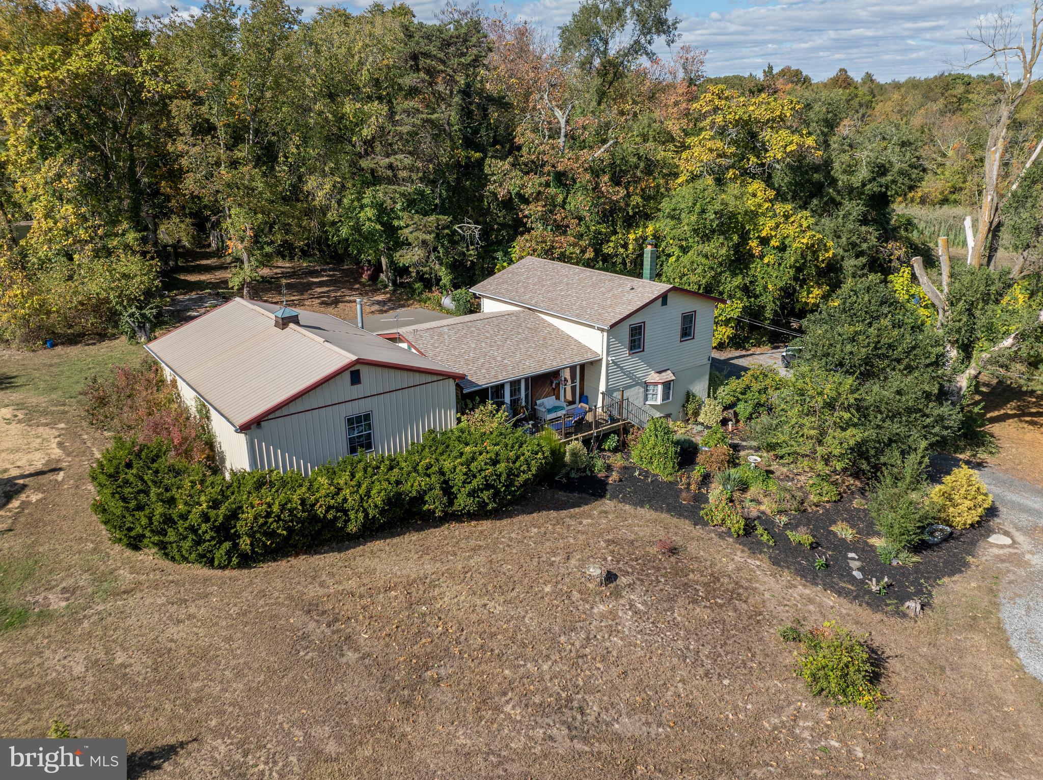 an aerial view of a house with a yard and lake view