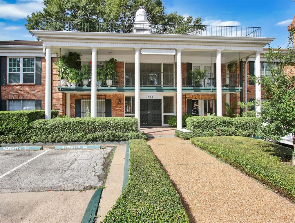 front view of a brick house with a yard