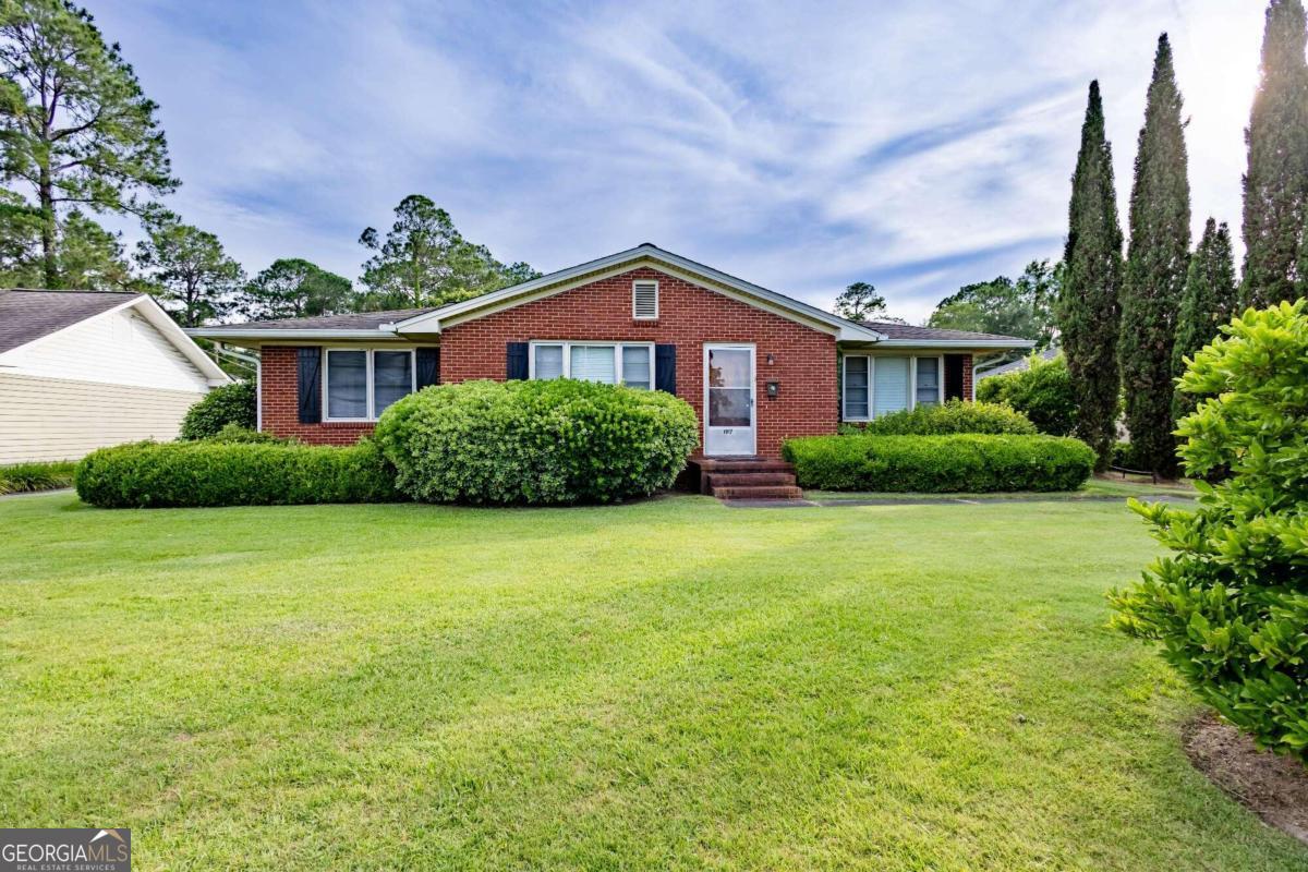 a front view of a house with garden