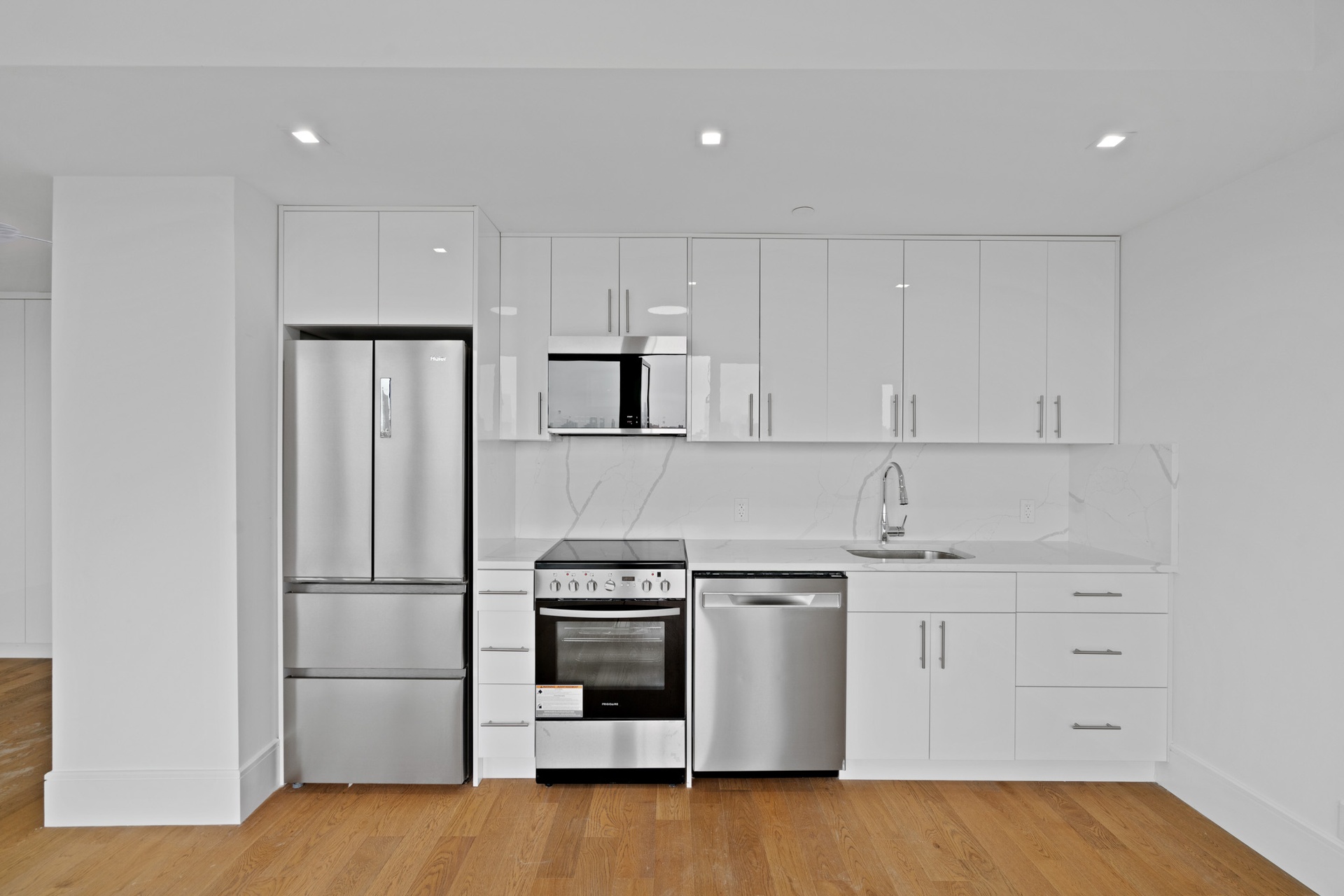 a kitchen with white cabinets and stainless steel appliances