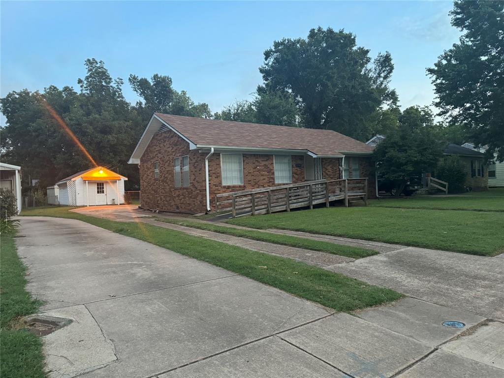 a front view of house with yard and green space