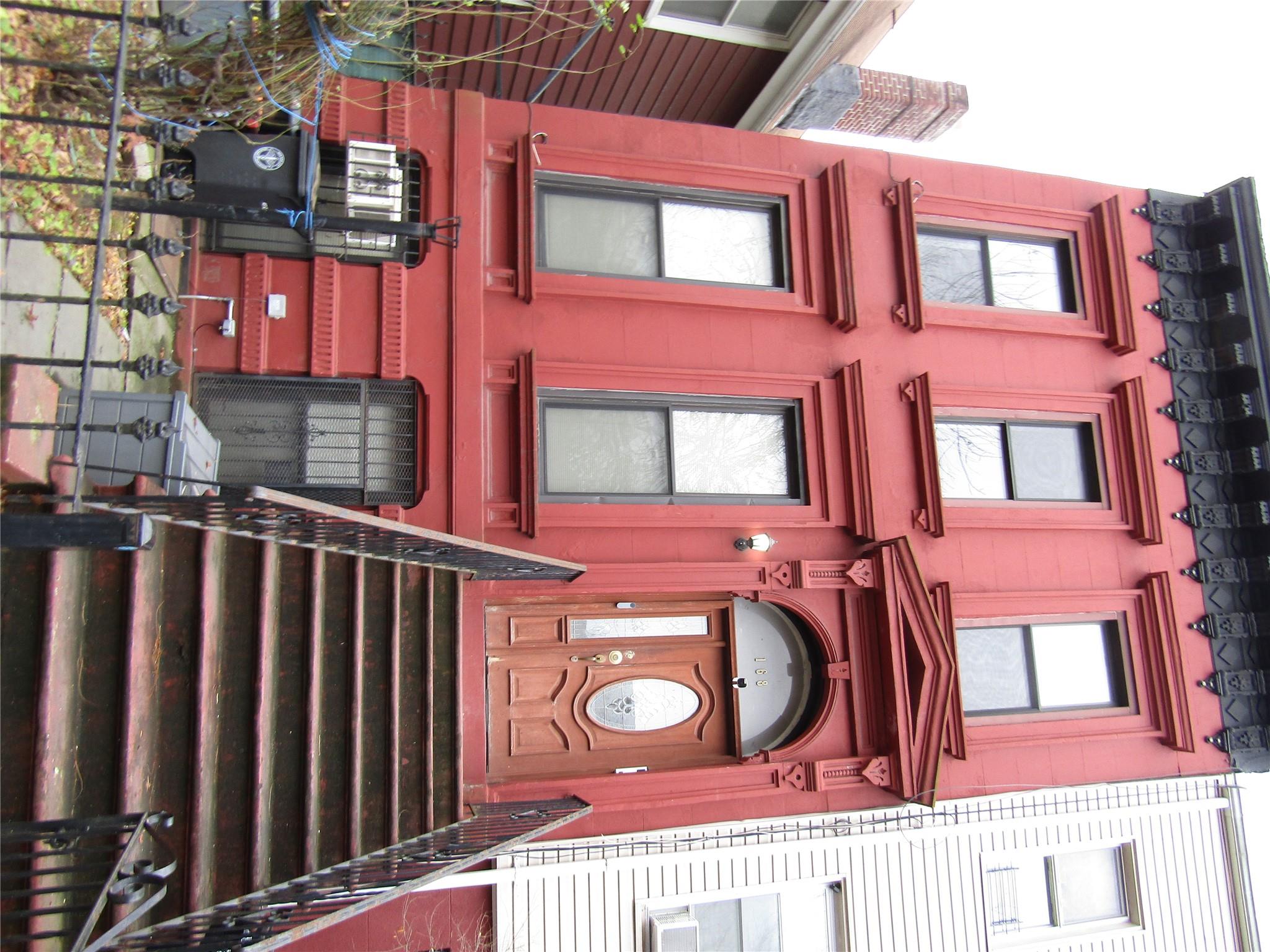 a view of a brick building with a large door