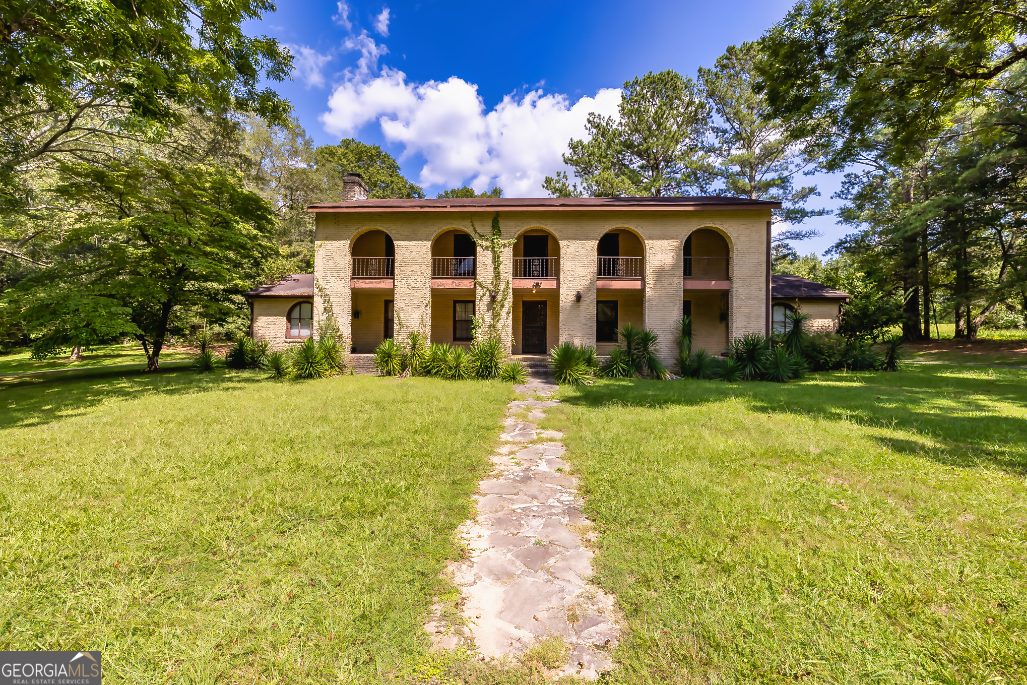 a front view of house with yard and green space