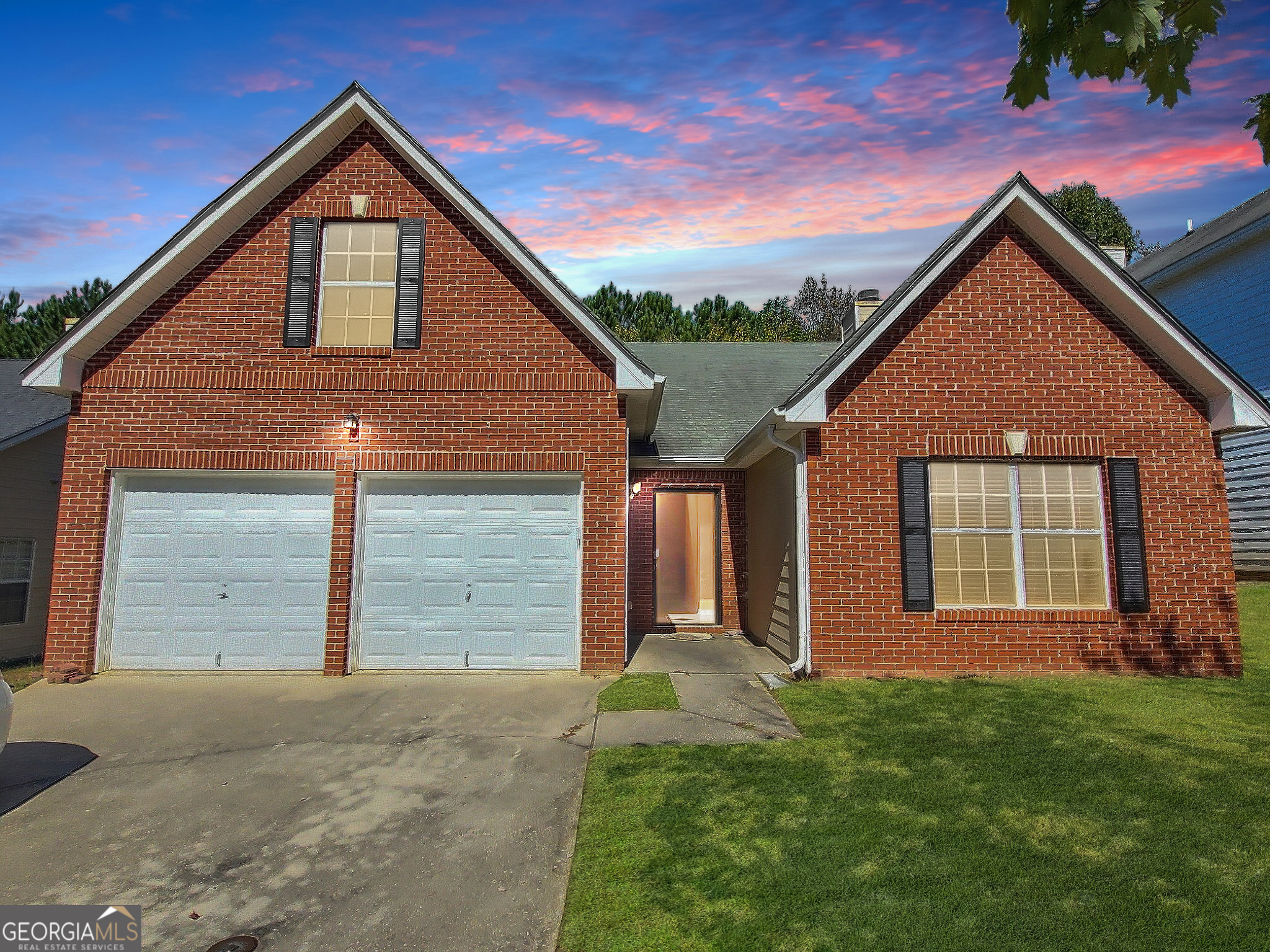 a front view of a house with a yard and garage