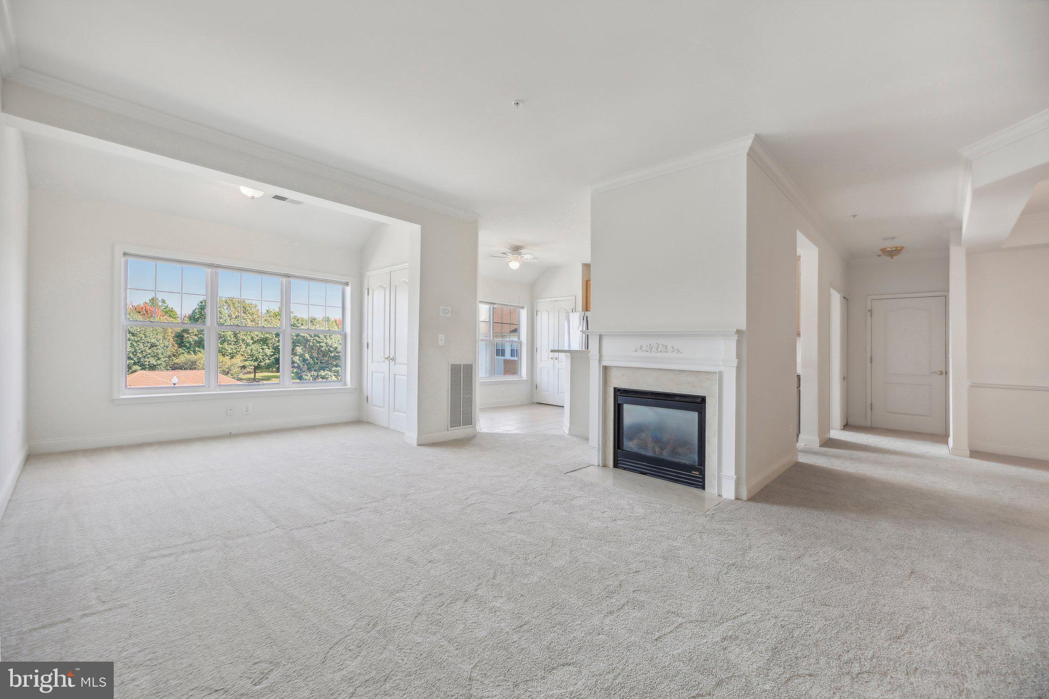 a view of a livingroom with an empty space and a fireplace