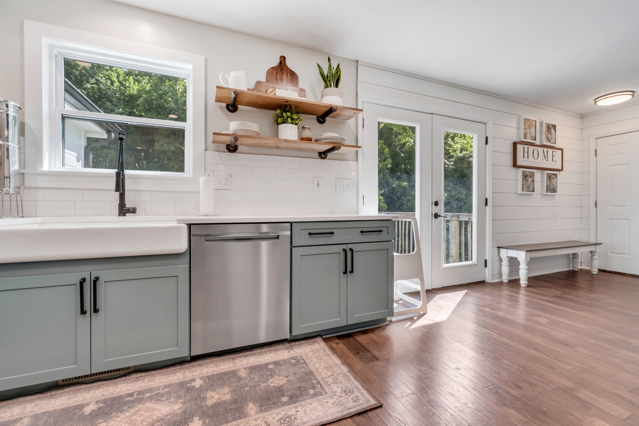 a kitchen with stainless steel appliances granite countertop a sink and wooden cabinets