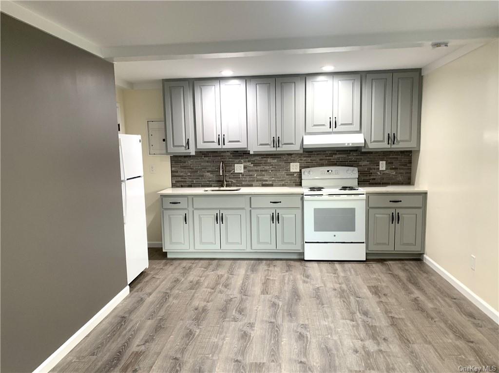 a kitchen with a stove a sink and a refrigerator