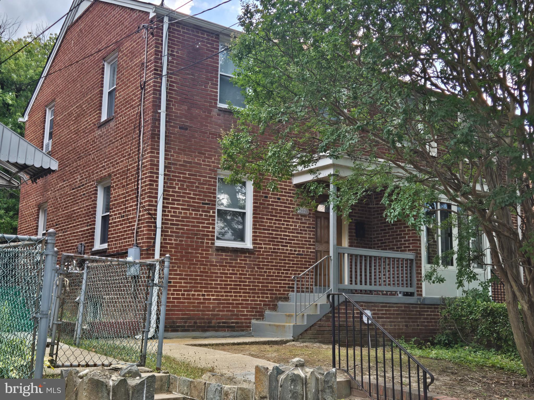 front view of a house with a tree