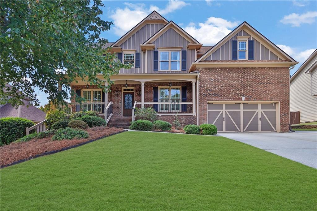 a front view of a house with a yard and garage