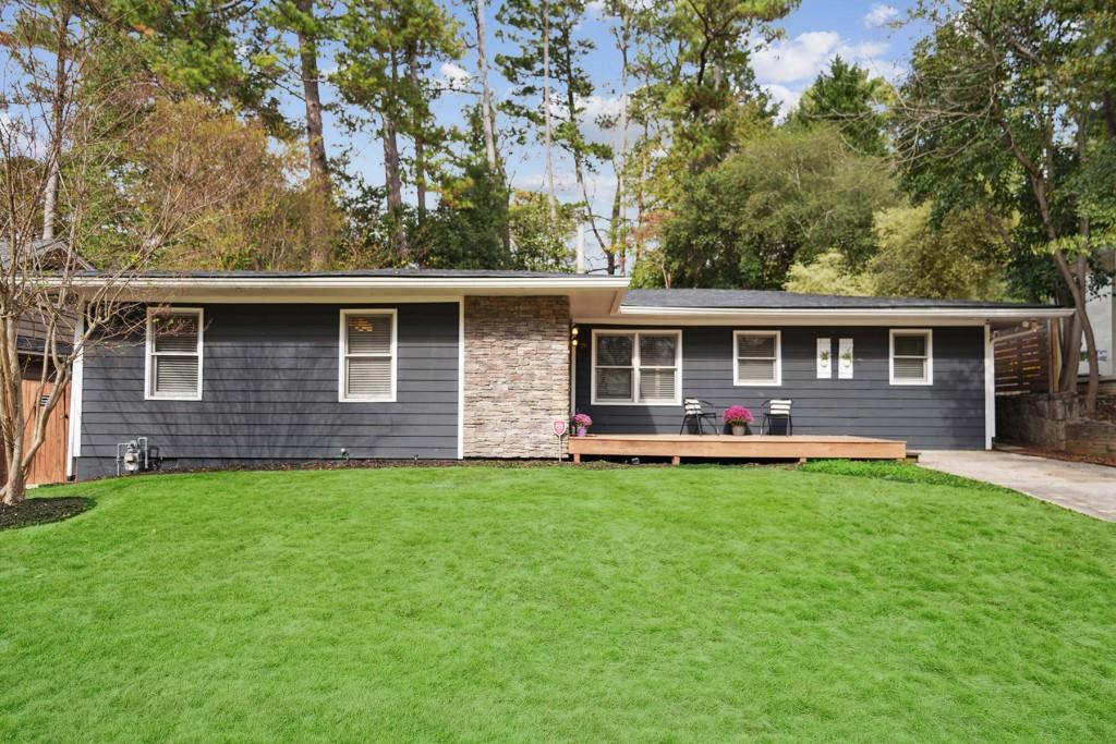 a view of a house with a backyard