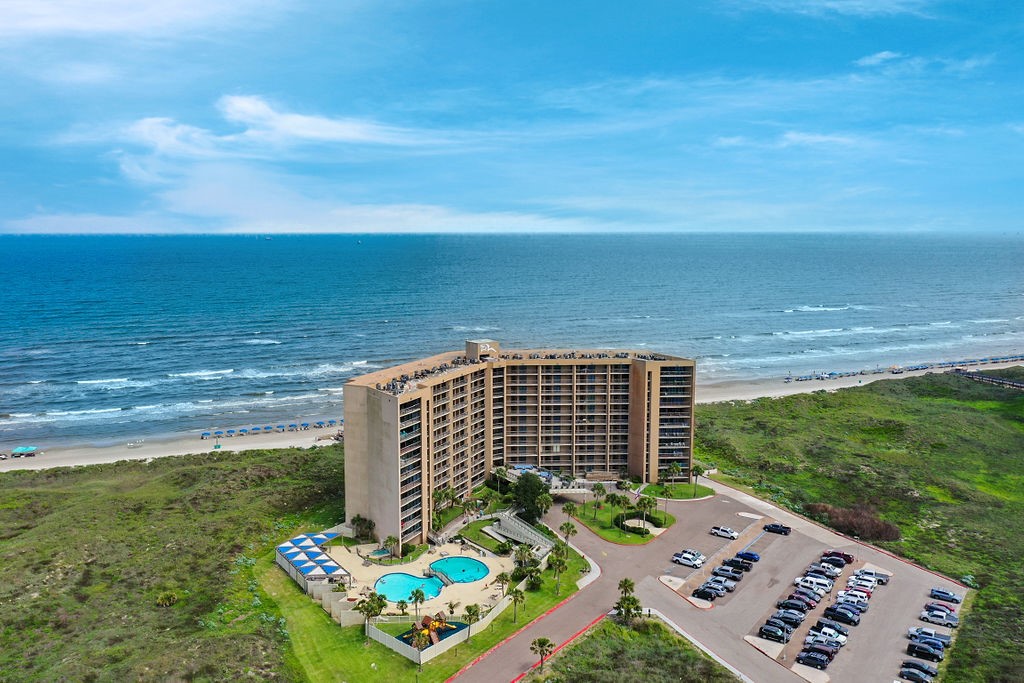 a view of a garden with an ocean view