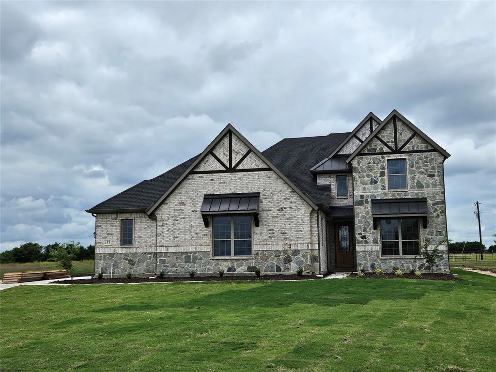 a front view of a house with a garden and deck