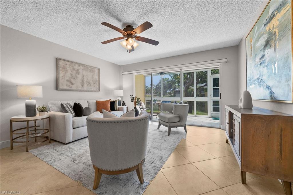 Open living room leads out to the glass-enclosed, screened lanai.