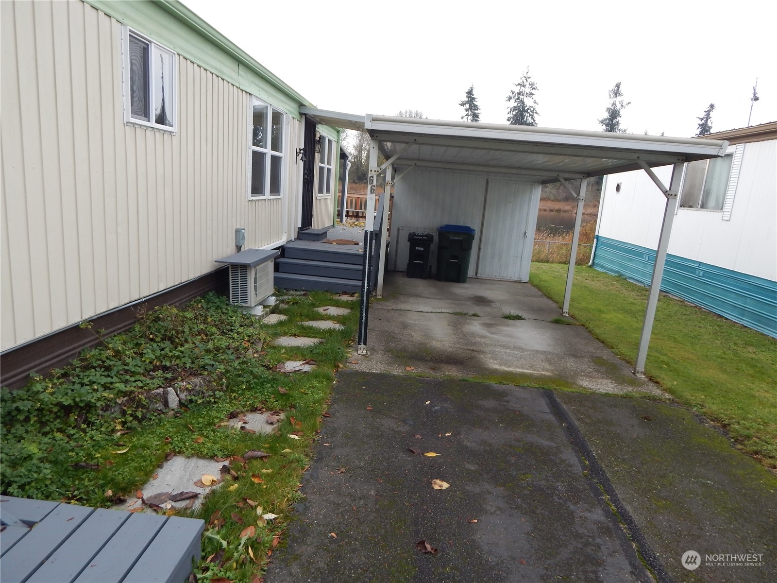 a view of backyard with barbeque grill and wooden fence