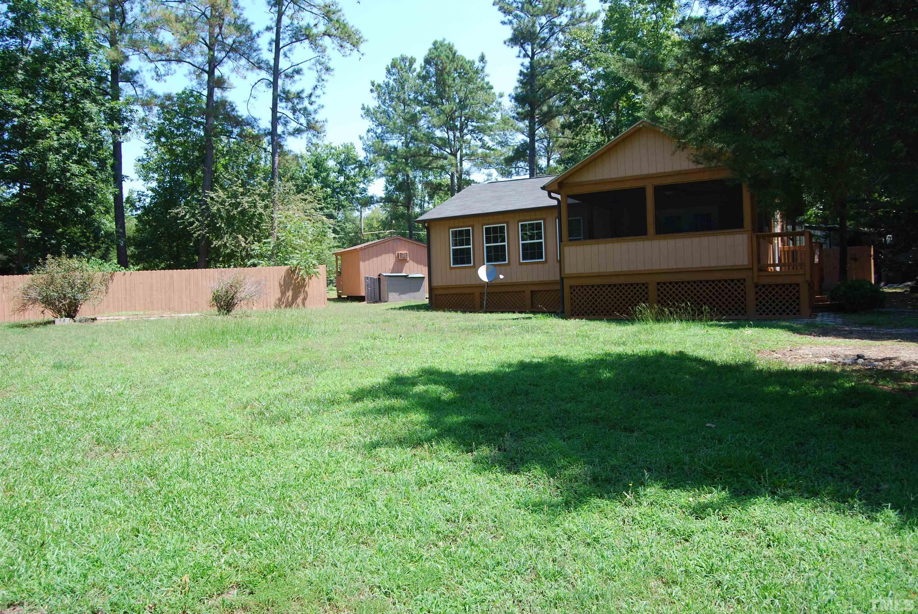 a front view of a house with yard and green space