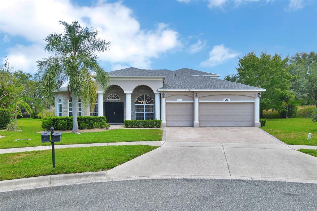 a front view of a house with a yard and garage