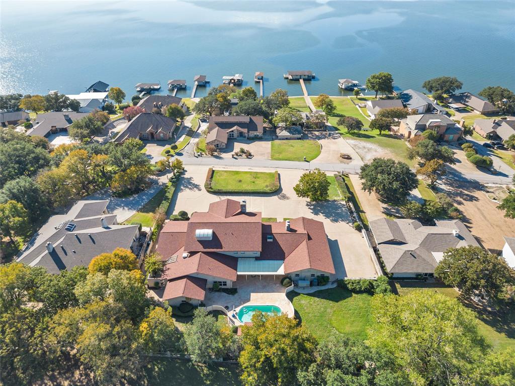 an aerial view of residential house with outdoor space swimming pool and ocean view