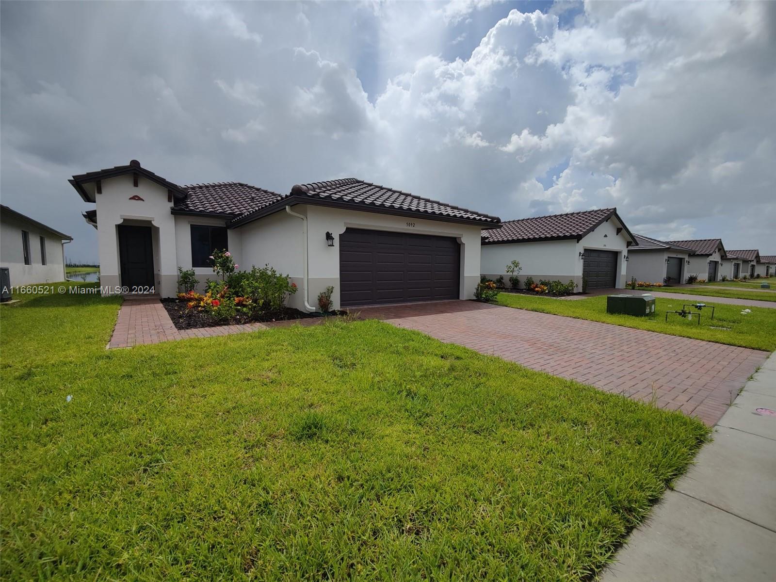 a front view of house with yard and green space