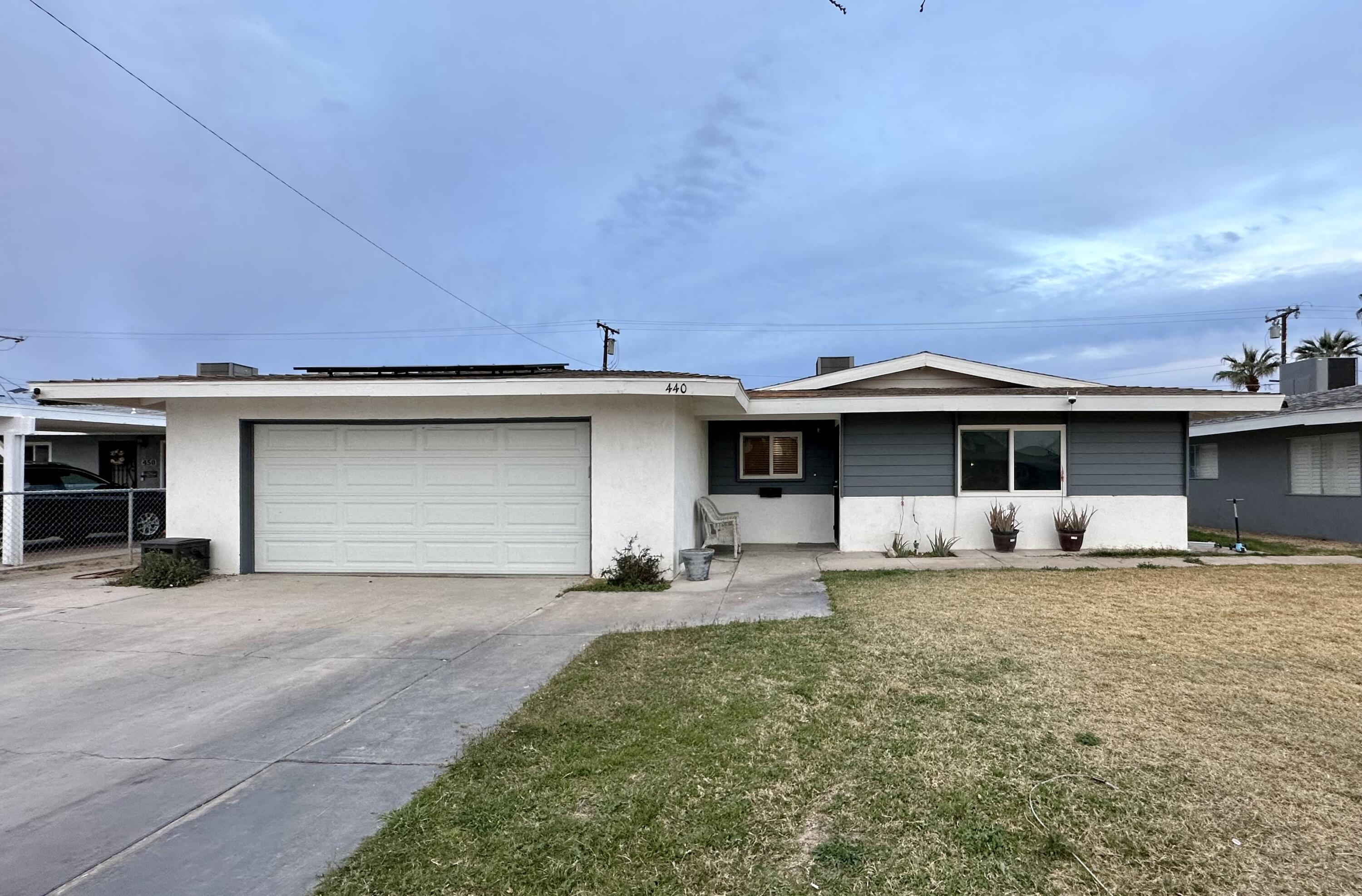 a front view of a house with a yard and garage