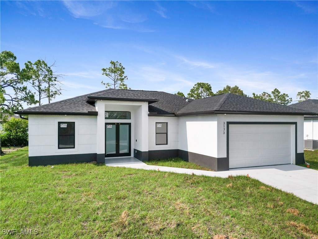 a front view of a house with a yard and garage