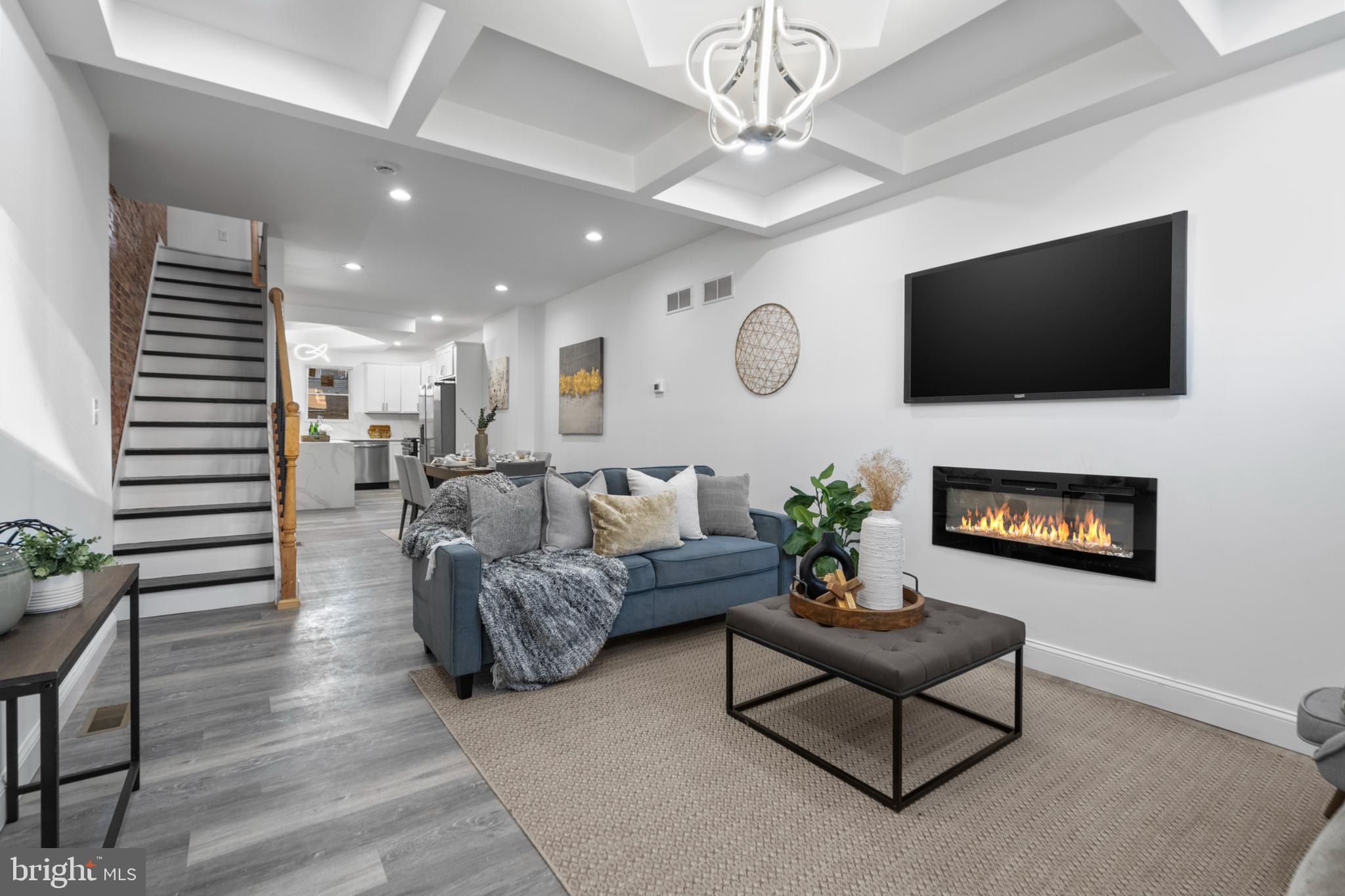 a living room with furniture a fireplace and a flat screen tv