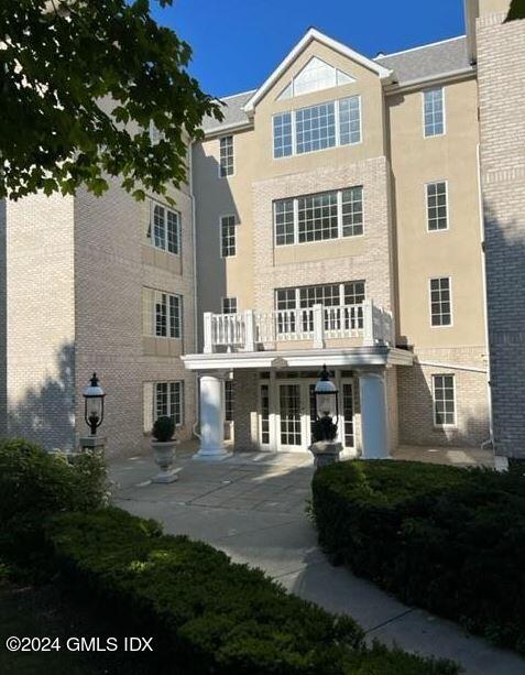 a front view of a residential apartment building with a yard