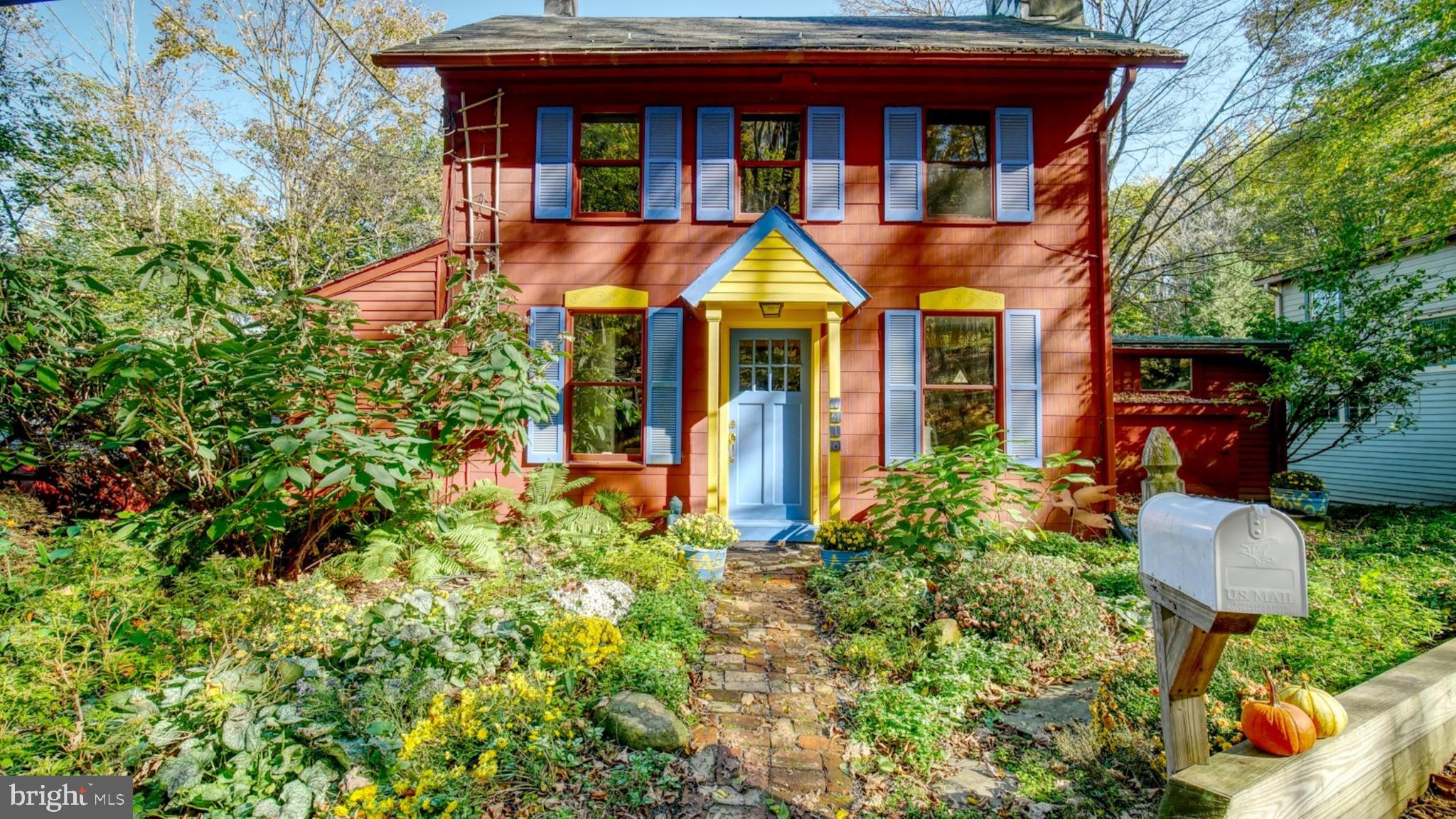 a front view of a house with lots of trees