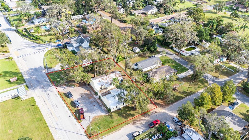 an aerial view of a residential houses with yard