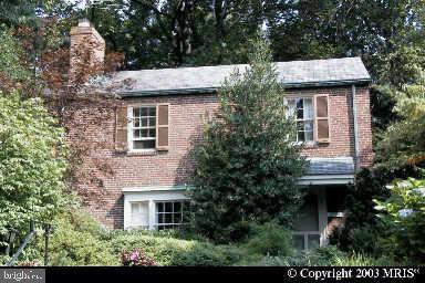 front view of a house with a tree