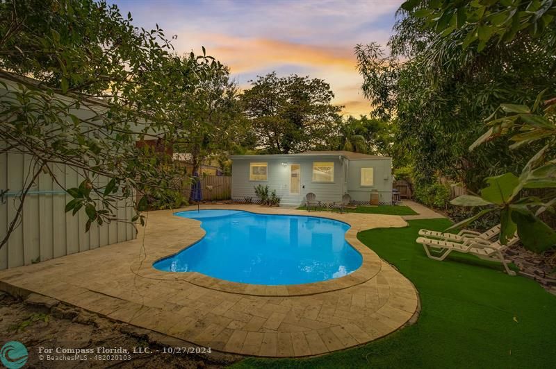 a view of a swimming pool with a yard