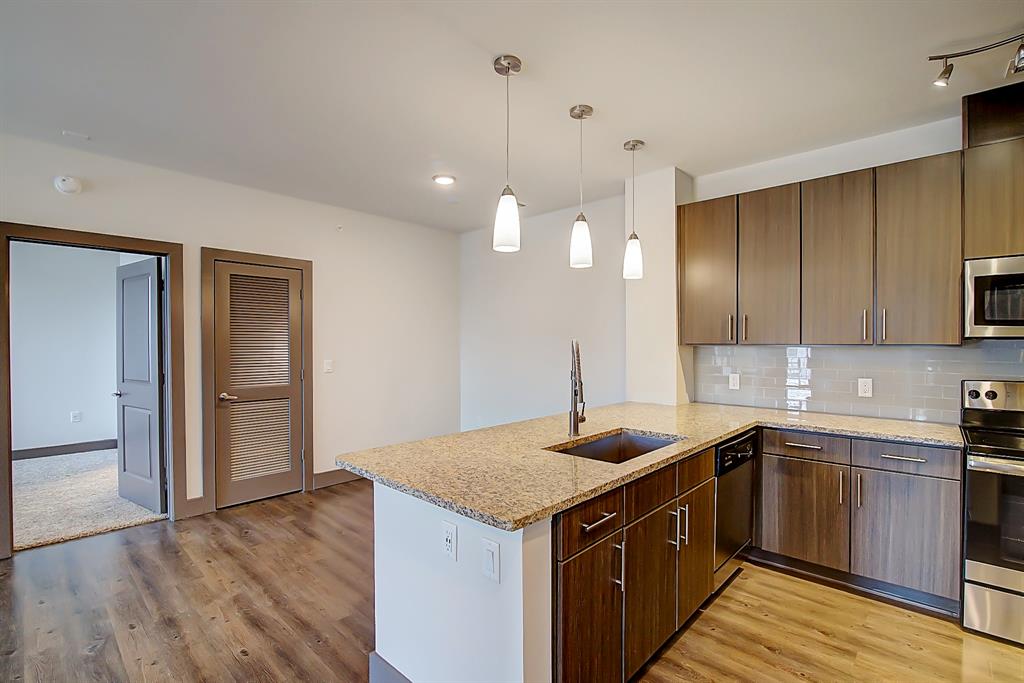 a kitchen with a sink and a stove top oven