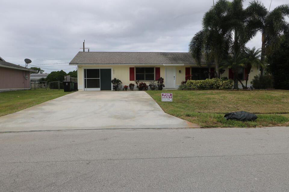 a front view of house with a garden