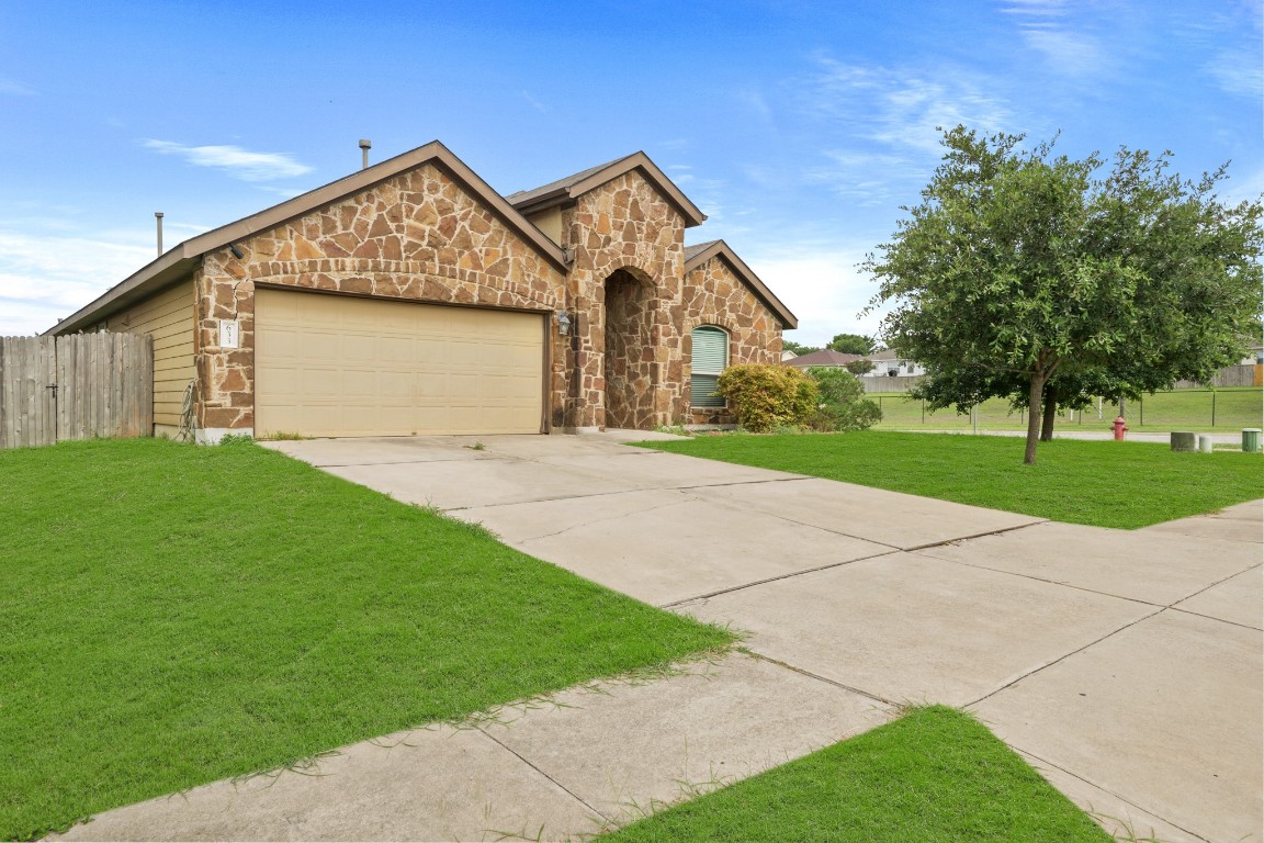 a front view of a house with a yard and garage