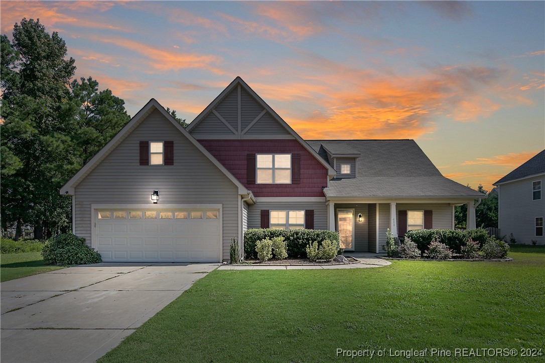 a front view of a house with a yard and garage