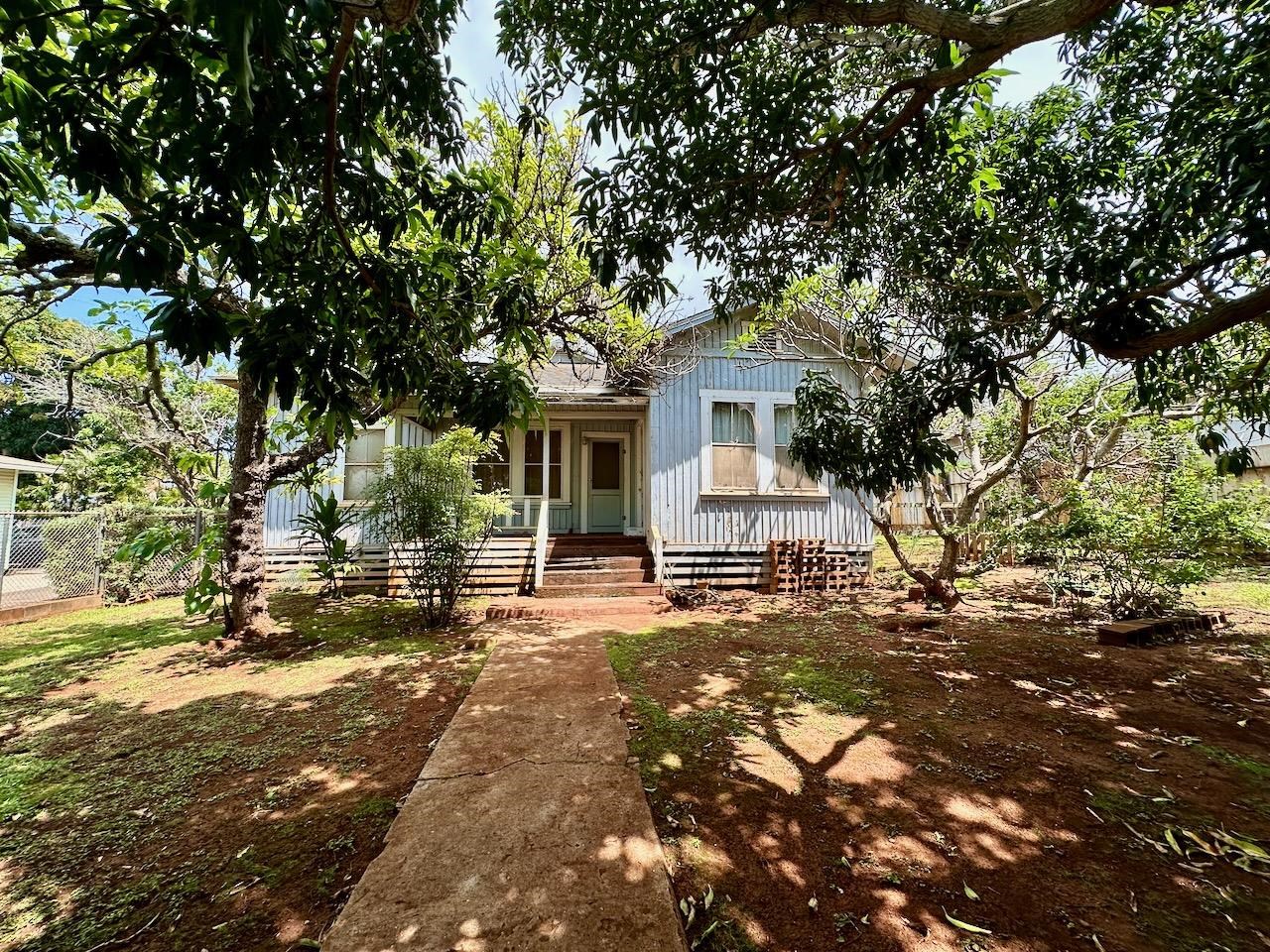 a view of a house with a tree in the background