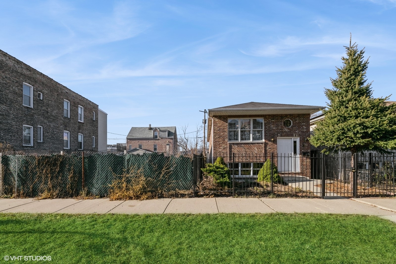 a front view of a house with yard and green space